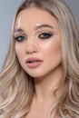 Close up portrait of beautiful blond young girl with perfect make up and liquid gel flowing on her face