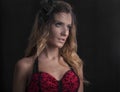 Close up portrait of beautiful blonde woman in red lingerie posing on black background Royalty Free Stock Photo