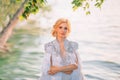 Close Up portrait. beautiful blonde woman in a white creative royal cloak with feathers. Decorated and embroidered with Royalty Free Stock Photo