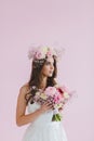 Close-up portrait of beautiful bride with flower wreath on her head