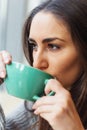 Close up portrait of beautiful brunette girl drinking coffee Royalty Free Stock Photo