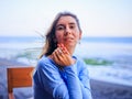 Close up portrait of beautiful Caucasian woman. Smiling woman wearing blue dress and sitting in the beach bar. Travel lifestyle. Royalty Free Stock Photo