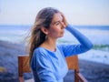 Close up portrait of beautiful Caucasian woman. Woman wearing blue dress and sitting in the beach bar. Travel lifestyle. Enjoy Royalty Free Stock Photo