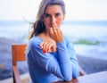 Close up portrait of beautiful Caucasian woman. Woman wearing blue dress and sitting in the beach bar. Travel lifestyle. Enjoy Royalty Free Stock Photo