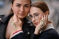 portrait of beautiful women faces with female hands decorated with small daisy flowers Royalty Free Stock Photo