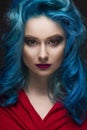 Close-up portrait of beautiful dyed blue colour hair girl wearing red scarf