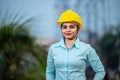 Close up portrait of beautiful female engineer wearing a protective helmet and looking at camera Royalty Free Stock Photo