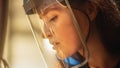 Close Up Portrait of Beautiful Female Fabricator in Safety Mask. She is Grinding a Metal Object. E