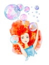 Close-up portrait of a beautiful girl in a blue dress with red hair and blue eyes.Surrounded by big soap bubbles.Catches them with Royalty Free Stock Photo