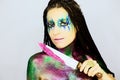 Close up portrait of a beautiful girl with creative glitter make up with knife covered in glitter Royalty Free Stock Photo