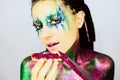 Close up portrait of a beautiful girl with creative glitter make up with knife and snack covered in glitter Royalty Free Stock Photo