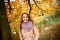 Close up portrait of a Beautiful girl in dark dress and black hat standing near colorful autumn leaves. Art work of romantic woman Royalty Free Stock Photo