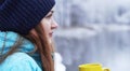 Close up portrait of a beautiful girl dreaming looking into the distance standing outdoor with cup of tea. Royalty Free Stock Photo