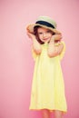 Close up portrait of a Beautiful girl in yellow dress and straw hat. Royalty Free Stock Photo