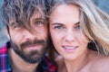 Close up and portrait of beautiful and handsome man and woman togethe with their faces near each other looking at the camera Royalty Free Stock Photo