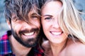 Close up and portrait of beautiful and handsome man and woman togethe with their faces near each other looking at the camera Royalty Free Stock Photo