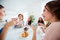 Close up portrait beautiful she her wondered ladies group buddies sit round big white table bright kitchen hold cups Royalty Free Stock Photo