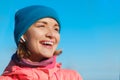 Close up portrait of beautiful laughing woman listening to music in earphones Royalty Free Stock Photo