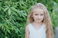 Close up portrait of beautiful little girl with blonde long hair and big blue eyes