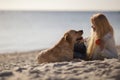 Close up portrait of beautiful long haired girl with her Labrador Retriever dog on the beach Royalty Free Stock Photo