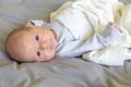 Close-up portrait of a beautiful month baby on grey blanket