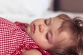 Close up portrait of a beautiful nine month old baby girl sleeping on blurred background. Sleeping child face. Cute Royalty Free Stock Photo