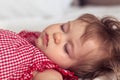 Close up portrait of a beautiful nine month old baby girl sleeping on blurred background. Sleeping child face. Cute Royalty Free Stock Photo