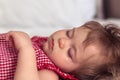 Close up portrait of a beautiful nine month old baby girl sleeping on blurred background. Sleeping child face. Cute Royalty Free Stock Photo