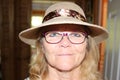 Close up portrait of a beautiful older senior woman smiling with hat Royalty Free Stock Photo