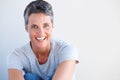 Close up beautiful older woman smiling against white wall Royalty Free Stock Photo