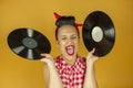 Close up portrait beautiful pin up girl with old vinil records Royalty Free Stock Photo