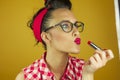 Close up portrait beautiful pin up girl putting on makeup Royalty Free Stock Photo