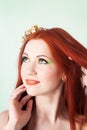 Close-up portrait of beautiful red-haired girl with flowers in hair Royalty Free Stock Photo