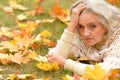 Close up portrait of beautiful sad senior woman on blurred autumn background Royalty Free Stock Photo