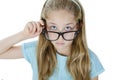Close-up portrait of beautiful serious focused blond girl wearing glasses holding frame and looking at camera