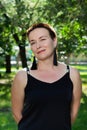 Close-up portrait of a beautiful short-haired woman in the park