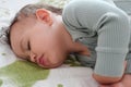 close-up portrait of a beautiful sleeping baby on bed. New family and baby protection from mom concept Royalty Free Stock Photo