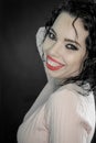 Portrait of a beautiful smiling young woman with curly black hair and red lipstick Royalty Free Stock Photo