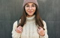 Close-up portrait of beautiful smiling young woman looking directly at the camera, walking in the city street, wearing knitted Royalty Free Stock Photo