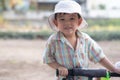 close up portrait of beautiful sweet boy, wearing White bucket hat and colorful shirt, looking at camera, big dark eyes Royalty Free Stock Photo