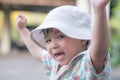 close up portrait of beautiful sweet boy, wearing White bucket hat and colorful shirt, looking at camera, big dark eyes Royalty Free Stock Photo