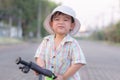 close up portrait of beautiful sweet boy, wearing White bucket hat and colorful shirt, looking at camera, big dark eyes Royalty Free Stock Photo