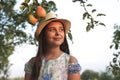 Close up portrait of a beautiful teen girl in white hat and dress with flowers print that looking at the up right corner Royalty Free Stock Photo