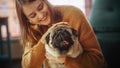 Close-up Portrait Beautiful Woman Holding Adorable Little Pug at Home. Girl Plays with Her Dog Royalty Free Stock Photo