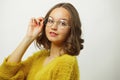 Close-up portrait of beautiful woman in round spectacles for vision over white isolated.