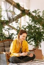 Close-up portrait beautiful woman sitting at garden while holding digital tablet. Young attractive happy woman is using tablet Royalty Free Stock Photo