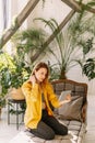 Close-up portrait beautiful woman sitting at garden while holding digital tablet. Young attractive happy woman is using tablet Royalty Free Stock Photo