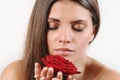 Close up portrait of beautiful woman smelling red rose Royalty Free Stock Photo