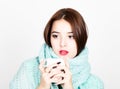 Close-up portrait of beautiful woman in a woolen scarf, drinking hot tea or coffee from white cup Royalty Free Stock Photo