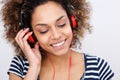 Close up beautiful young african american woman listening to music with headphones Royalty Free Stock Photo